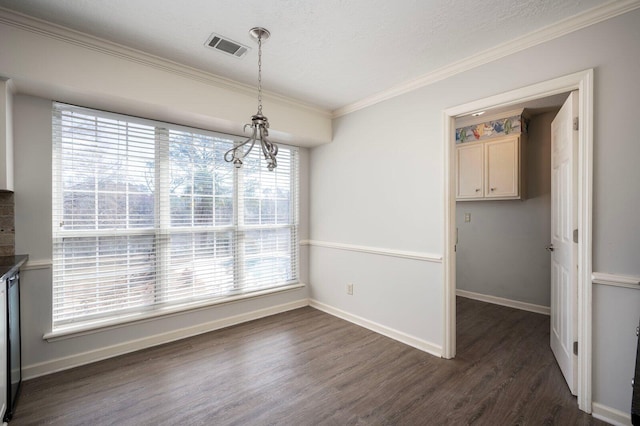 unfurnished dining area with baseboards, visible vents, dark wood-type flooring, and ornamental molding