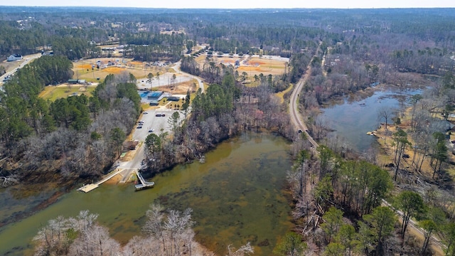 aerial view featuring a forest view and a water view