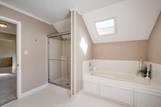 bathroom featuring a stall shower, vaulted ceiling with skylight, baseboards, and a bath