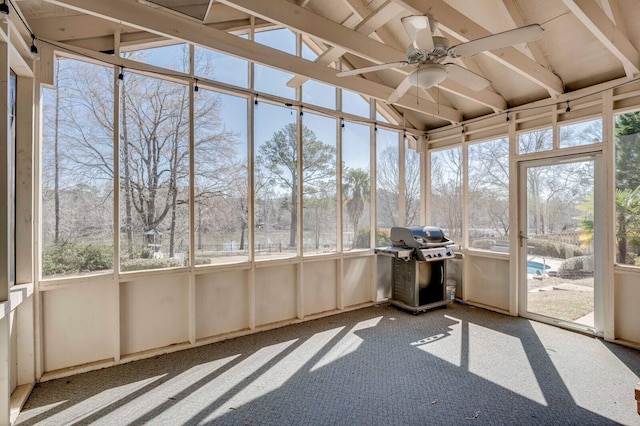 unfurnished sunroom with vaulted ceiling and ceiling fan