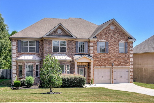 view of front facade with a front yard and a garage