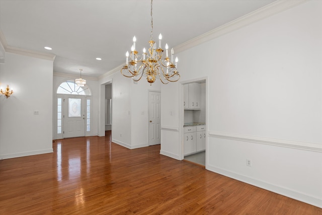 interior space with wood-type flooring and ornamental molding