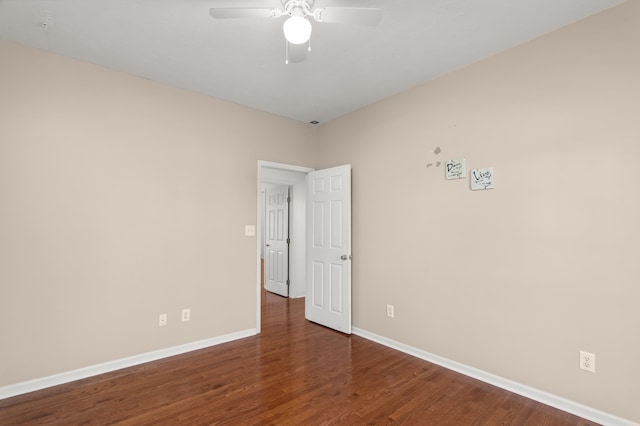 spare room featuring ceiling fan and dark hardwood / wood-style flooring