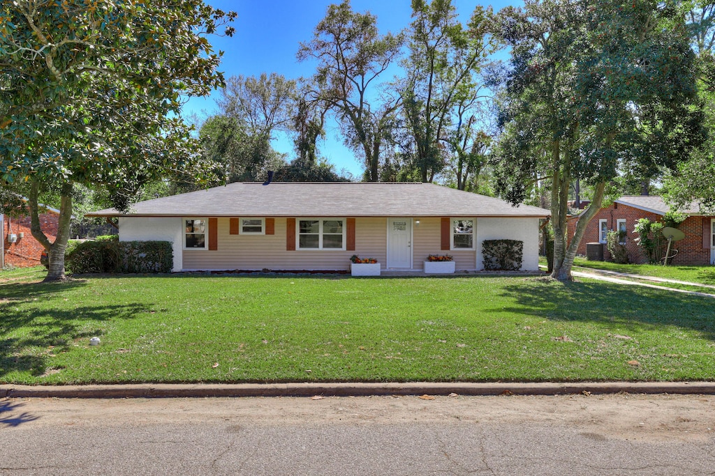 single story home featuring a front lawn