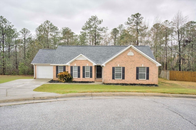 view of front of house featuring driveway, a front lawn, fence, a garage, and brick siding