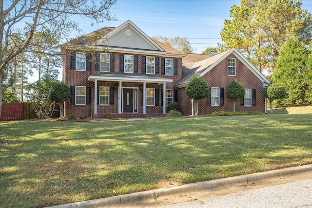 colonial inspired home featuring a front yard and central AC unit