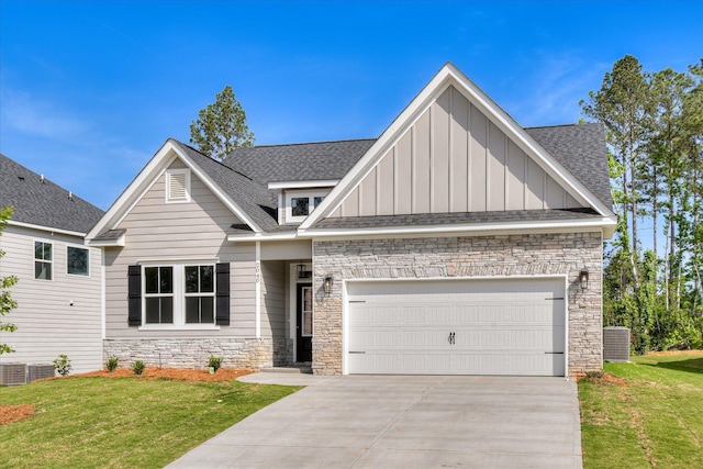 craftsman inspired home featuring an attached garage, stone siding, board and batten siding, concrete driveway, and cooling unit