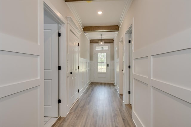 corridor featuring crown molding, recessed lighting, light wood-type flooring, and a decorative wall