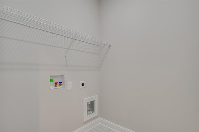 clothes washing area featuring baseboards, laundry area, washer hookup, and hookup for an electric dryer