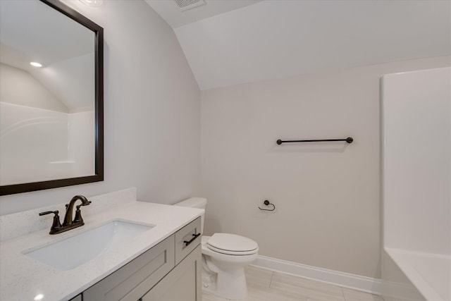 full bath featuring vanity, toilet, baseboards, a bathing tub, and vaulted ceiling