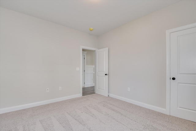 carpeted empty room with baseboards