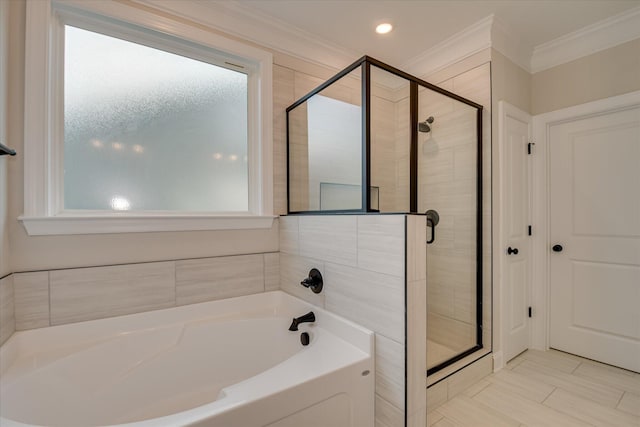 bathroom with crown molding, a shower stall, and a garden tub
