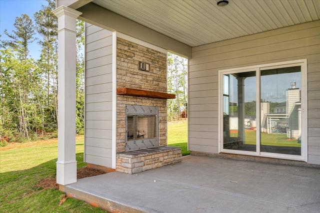 view of patio featuring an outdoor stone fireplace