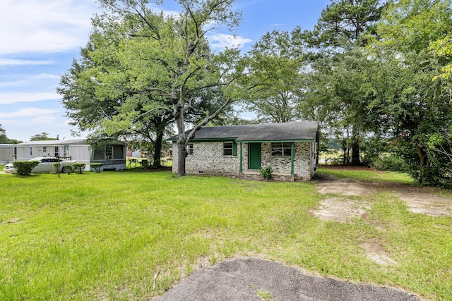 view of front of property with a front yard and a sunroom