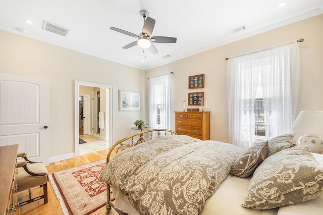 bedroom with visible vents, multiple windows, ornamental molding, and light wood finished floors