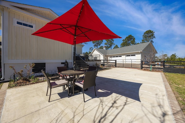 view of patio featuring outdoor dining area and fence