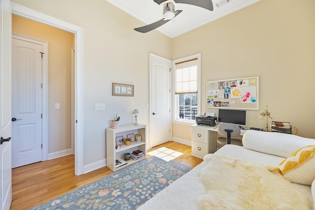 bedroom with crown molding, wood finished floors, and baseboards