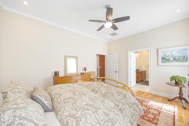 bedroom featuring crown molding, baseboards, visible vents, and light wood finished floors