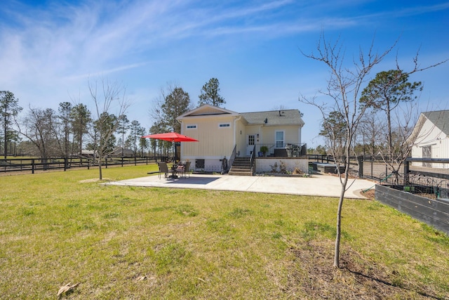 rear view of property featuring a patio area, a lawn, a fenced backyard, and crawl space