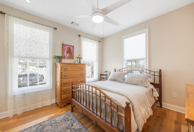 bedroom featuring visible vents, wood finished floors, recessed lighting, baseboards, and ceiling fan