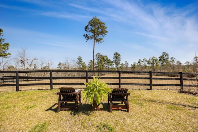 view of yard with a rural view and fence