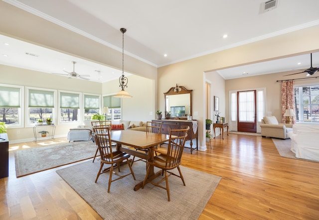 dining space featuring light wood-style flooring, visible vents, and ceiling fan