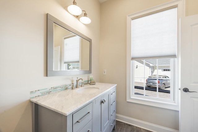 bathroom with vanity, baseboards, and wood finished floors