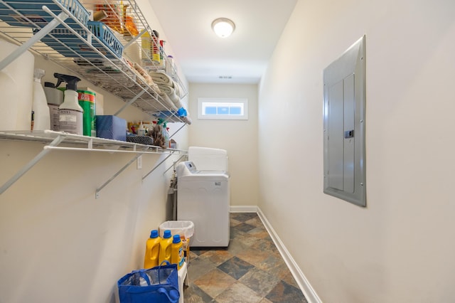 laundry room with baseboards, washer / dryer, laundry area, electric panel, and stone finish flooring