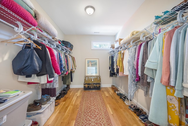 walk in closet featuring visible vents and wood finished floors