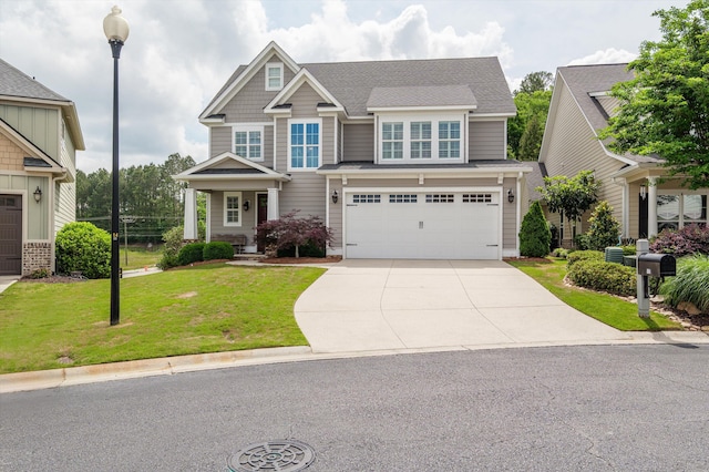 884 Willow Lk, Evans, GA 30809 - craftsman house featuring concrete driveway, a front yard, an attached garage, and a shingled roof