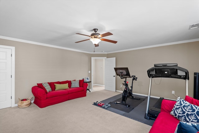 workout area with ceiling fan, light colored carpet, and ornamental molding