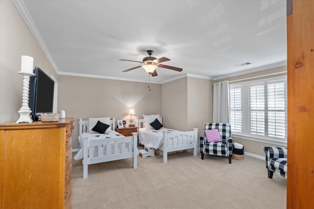 bedroom with ornamental molding, carpet, and ceiling fan