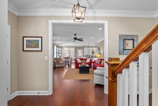 living room featuring crown molding, dark hardwood / wood-style floors, and ceiling fan with notable chandelier