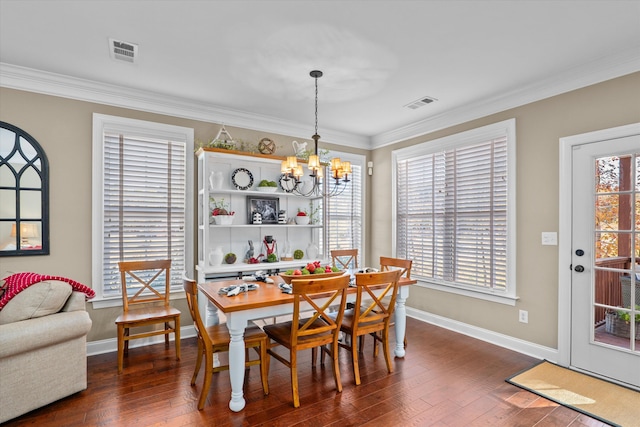 dining space featuring ornamental molding, dark hardwood / wood-style flooring, and an inviting chandelier