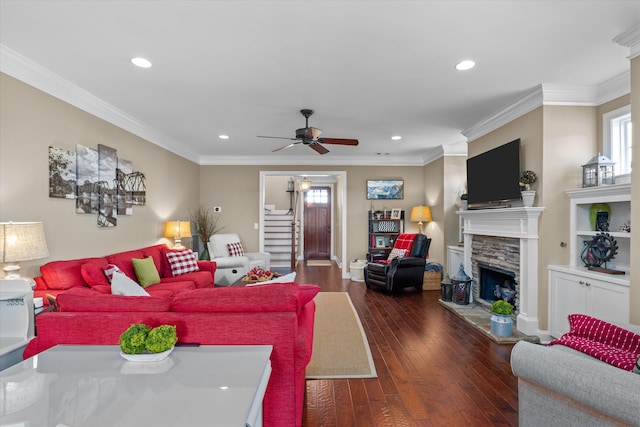 living room featuring dark hardwood / wood-style flooring, a fireplace, ceiling fan, and plenty of natural light