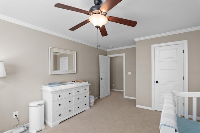 carpeted bedroom featuring crown molding, ceiling fan, and a crib