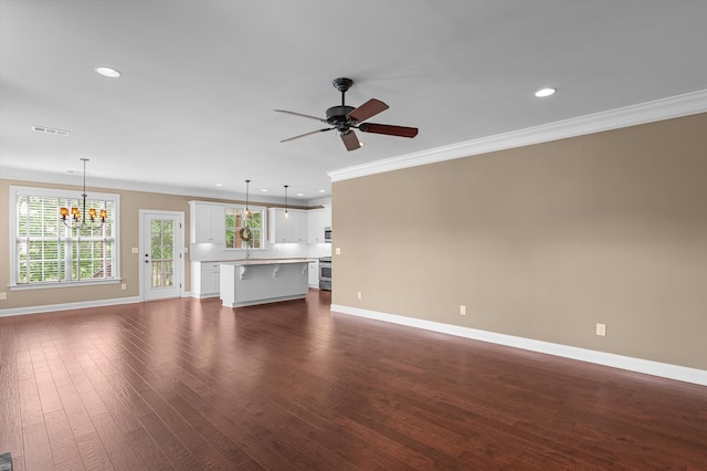 884 Willow Lk, Evans, GA 30809 - unfurnished living room featuring crown molding, visible vents, baseboards, and ceiling fan with notable chandelier