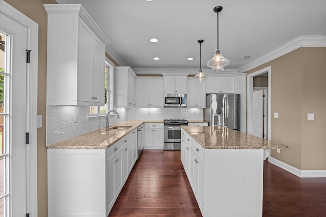 884 Willow Lk, Evans, GA 30809 - kitchen with a sink, stainless steel appliances, tasteful backsplash, a center island, and light stone counters