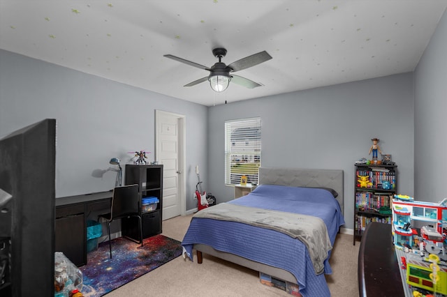 carpeted bedroom with baseboards and a ceiling fan