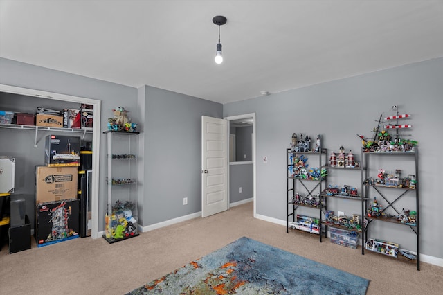 playroom featuring baseboards and carpet