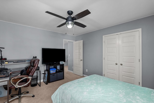 carpeted bedroom featuring a closet, a ceiling fan, and baseboards