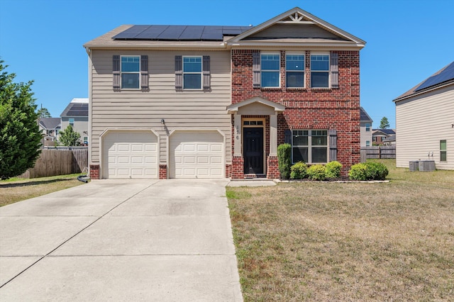 craftsman-style home with fence, a front lawn, and brick siding