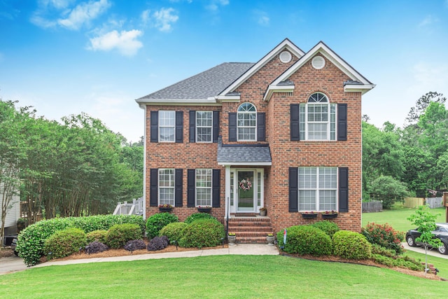 4161 Eagle Nest Dr, Evans, GA 30809 - view of front of home with brick siding, a front yard, and a shingled roof