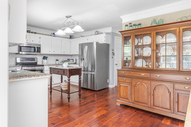 4161 Eagle Nest Dr, Evans, GA 30809 - kitchen featuring stainless steel appliances, ornamental molding, light stone counters, tasteful backsplash, and dark wood-style flooring