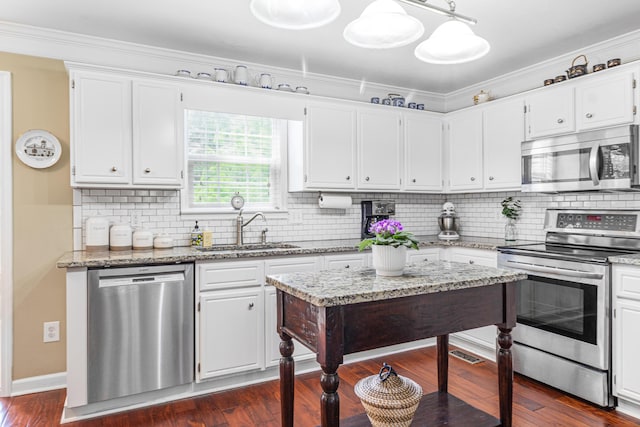 4161 Eagle Nest Dr, Evans, GA 30809 - kitchen with stainless steel appliances, a sink, white cabinets, tasteful backsplash, and ornamental molding