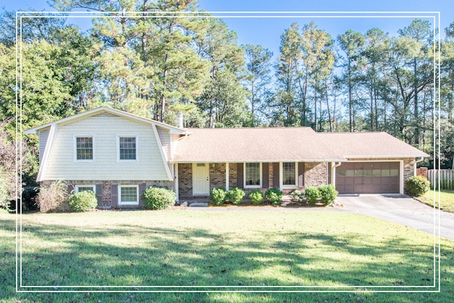 split level home with a porch, a garage, and a front lawn