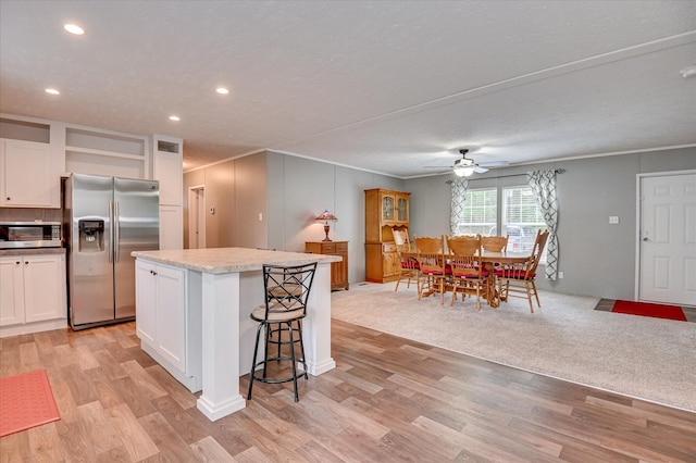1711 Carolyn Lake Cir, Thomson, GA 30824 - kitchen with appliances with stainless steel finishes, ceiling fan, a center island, white cabinets, and open shelves