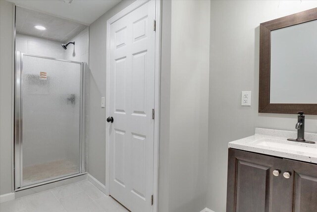 bathroom with vanity, tile patterned floors, and an enclosed shower