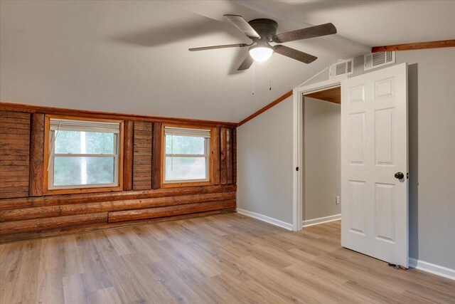 unfurnished bedroom with multiple windows, ceiling fan, light hardwood / wood-style flooring, and vaulted ceiling