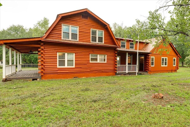 back of house featuring a lawn and a porch